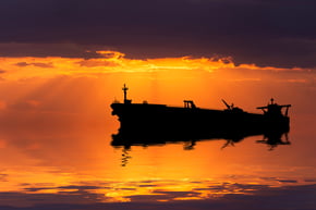 Oil tanker against sunset