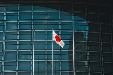 Japan flag in front of glass building