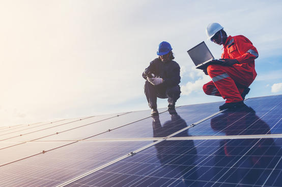 workers fixing solar panels 3