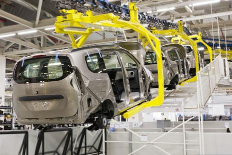 cars on a production line being assembled