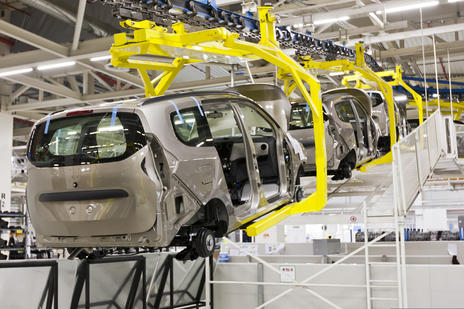 cars on a production line being assembled