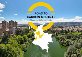 Road to Carbon Neutral text and graphic in centre. Photograph of Bogota city skyline behind. 