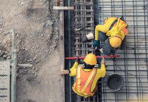 Concrete workers on concrete slab