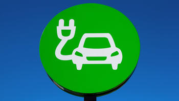 Green sign of drawn car with electric plug on blue background