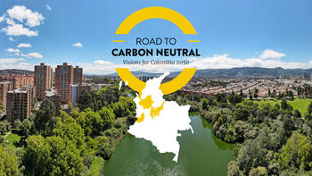 Road to Carbon Neutral text and graphic in centre. Photograph of Bogota city skyline behind. 